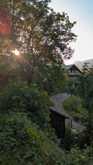 Sunset in the picturesque village of Saravillo, with the warm sunlight illuminating its streets and houses, surrounded by the mountainous landscape of the Chistau Valley, Aragon Pyrenees.
