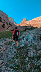 Trekker on the way to the Agujas de Lavasar, surrounded by impressive peaks and a rocky landscape of the Aragon Pyrenees, facing the majestic nature of the Chistau Valley.
