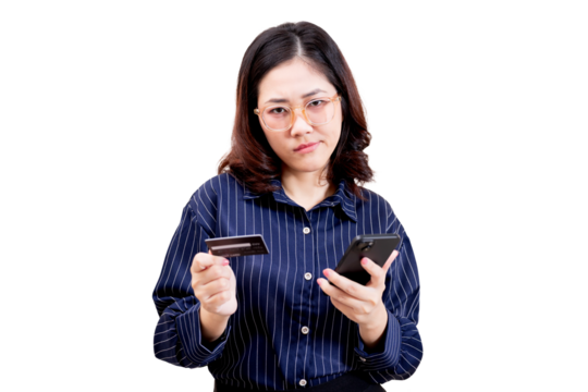 Asian young beautiful woman wearing glasses and a striped shirt holds a credit card in one hand and a smartphone in the other, looking focused and thoughtful. - Powered by Adobe