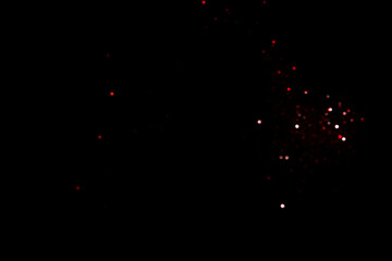 Red blurred bokeh lights on black background. Glitter sparkle confetti