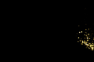 Golden blurred bokeh lights on black background