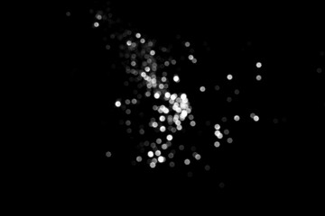 White gray blurred bokeh lights on black background