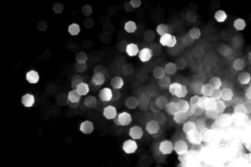 White gray blurred bokeh lights on black background