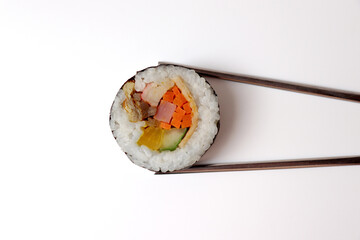 Kimbap picked up with chopsticks. Korean food.