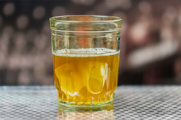A glass of juice with a softly blurred background