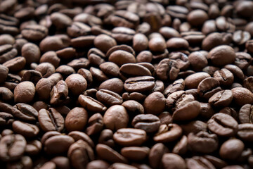 Roasted coffee beans close-up macro shot.Rough textured background pattern.