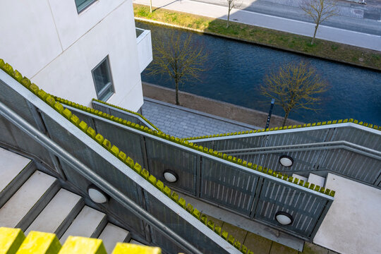 Overhead view of stairs and yellow railing in a layered architectural structure, showing contrast and composition in modern building design