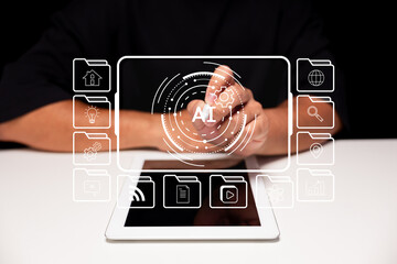 A person interacts with a transparent digital interface displaying AI and various technology icons above a tablet on a white surface.