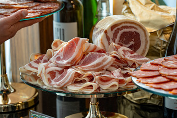 Close-up photo of sliced marbled meat with visible fat streaks. The juicy and tender texture makes...