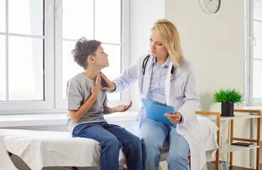 Boy in the clinic complains to the doctor about a sore throat, close-up. Female pediatrician in the...