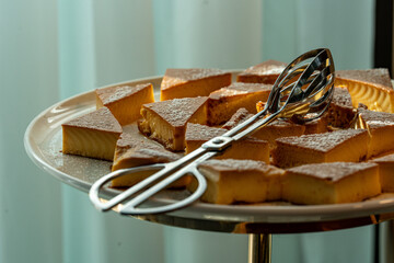 Photo of a variety of desserts arranged on a buffet table. The colorful selection includes cakes,...