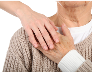 A young hand gently rests on the hand of an elderly person wearing a knitted sweater, symbolizing care and support.
