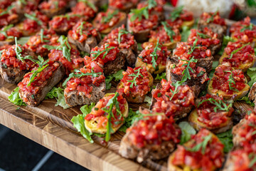 Photo of crispbread crackers topped with a vibrant red spread, served in a restaurant setting. The appetizing snack features a smooth, flavorful paste, perfect for appetizers, tapas, or gourmet finger