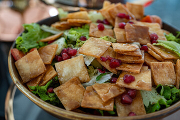 Photo of a tangy Lebanese salad featuring fresh pomegranate seeds and crunchy croutons. The vibrant...