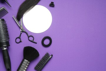 Different hairdresser's tools on purple background, flat lay. Space for text