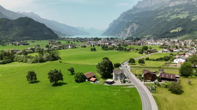 Scenic aerial view of rural countryside and Alpine mountain landscape near Flums, Berschis and Walenstadt on Lake Walensee, in the canton of St. Gallen, Switzerland &ndash; drone footage