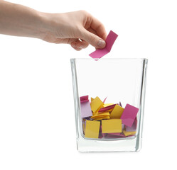 Woman taking color paper piece form glass holder on white background, closeup