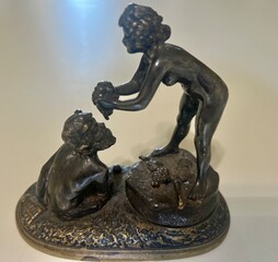 Greek God Pan (God of sheperds and hunters) eating grapes from a nude woman.