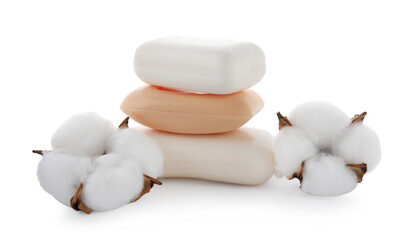 Stack of soap bars and cotton flowers isolated on white