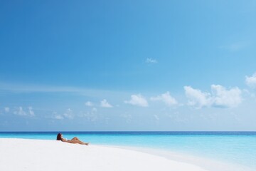 person lounging peacefully on pristine white sandy beach with clear blue skies above capturing essence of relaxation
