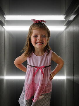 Happy Little Girl in Futuristic Lit Tunnel


