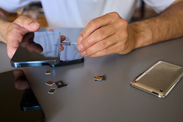 Detailed Process of Installing a SIM Card Utilizing Various Smartphone Components and Accessories