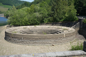 Ladybower, Derbyshire, England - June 20 2025: A dry bell-mouth spillway near a reservoir in beautiful sunshine.