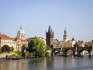 Charles Bridge and Vltava River with historical buildings in Prague