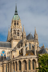 Fototapeta premium Bayeux Cathedral, exterior mid shot of the copper clad spire in the sunshine 