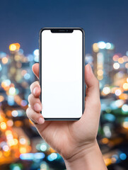 Person holding smartphone with blank white screen in front of blurred cityscape at night with colorful lights glowing softly