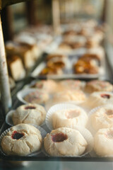 Jam-filled cookies and assorted pastries in a bakery display