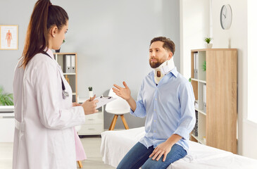 Patient with a neck trauma consulting with a doctor or nurse in a hospital office. The medical...