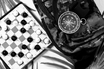 Retro compass and mini chess, entertainment during travel.