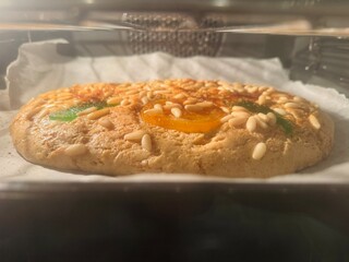 Homemade Sant Joan pastry baking on oven tray.