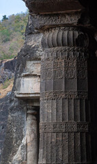 Ancient Cave Entrance with Stone Pillar