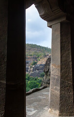 Ancient Cave Entrance with Stone Pillar