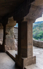 Ancient Cave Entrance with Stone Pillar