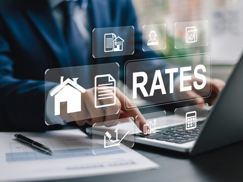 Corporate hands typing on laptop with floating tax icons and 'RATES' panel in a sleek office setting.