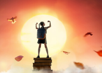 child on the tower of books