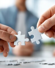 Business people company teamwork collaboration puzzle jigsaw concept. Colleagues Engaged in Collaborative Puzzle Fitting and Problem Solving in a Bright Office Setting