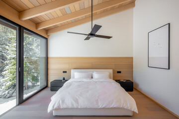 Modern Minimalist A-Frame Bedroom with Slanted Wooden Ceiling, Floor-to-Ceiling Window, Snowy Views, and Neutral Contemporary Design