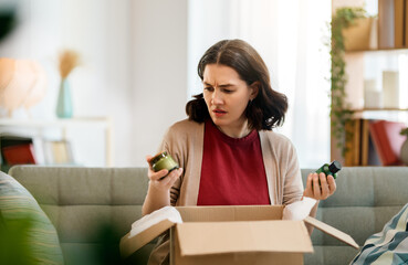 Woman is unpacking cardboard