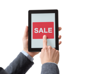 Hand touching a tablet screen with the word sale, promoting an online deal.
