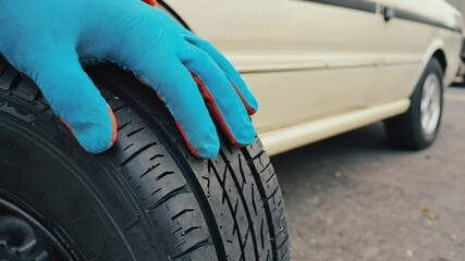 Tire maintenance process with gloves in outdoor setting