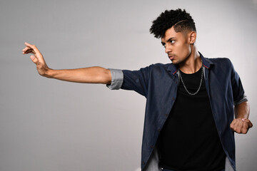 model young slim man in denim shirt in kung fu pose horizontal