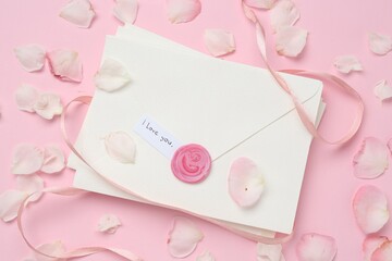 Stack of letters with phrase I Love You and petals on pink background, flat lay