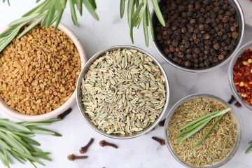 Different aromatic spices on white table, flat lay