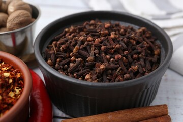 Different aromatic spices on white table, closeup