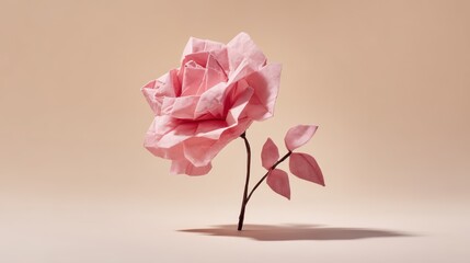 Fototapeta premium Elegant origami rose made from delicate pink tissue paper resting on a soft cream background with gentle shadows