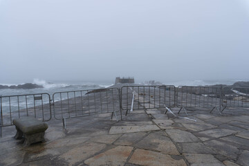 Concrete pier with metal railings on Atlantic Ocean shore